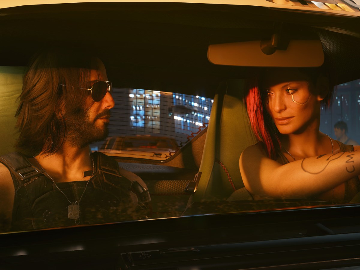 Screenshot aus Cyberpunk 2077. Zu sehen ist Protagonistin V im Auto mit dem von Keanu Reeves verkörperten Johnny Silverhand.