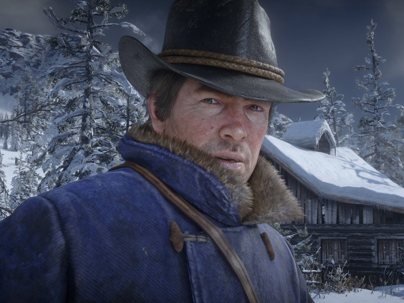 Screenshot aus Red Dead Redemption 2. Zu sehen ist Protagonist Arthur Morgan in Winterkleidung.